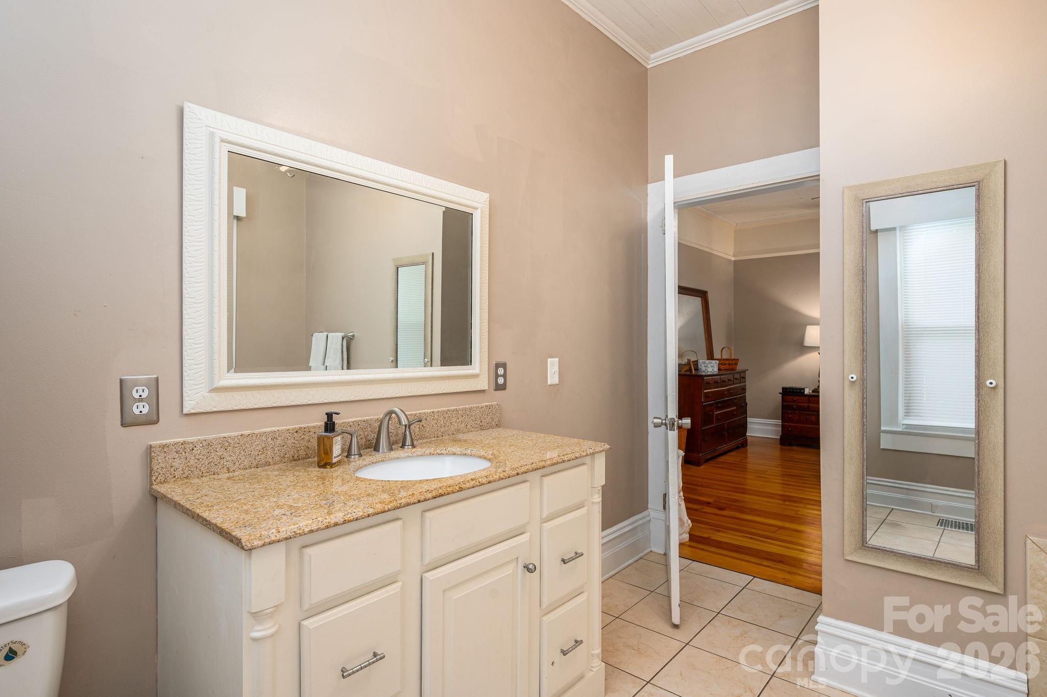 306 West Old Post Road Cherryville, NC 28021 - Photo 20 of 42 a bathroom with a granite countertop sink and a mirror