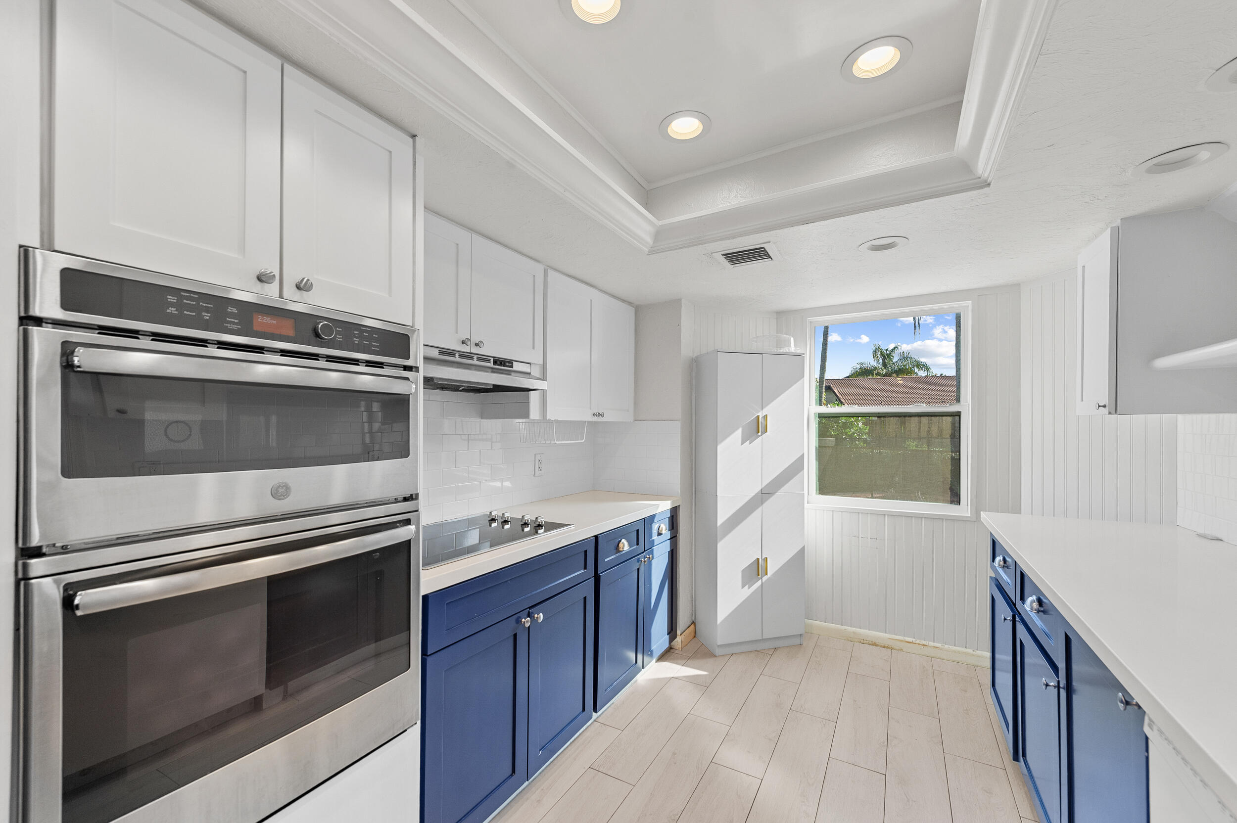 21089 Brookshire Terrace Boca Raton, FL 33433 - Photo 11 of 30 a kitchen with stainless steel appliances white cabinets and a stove