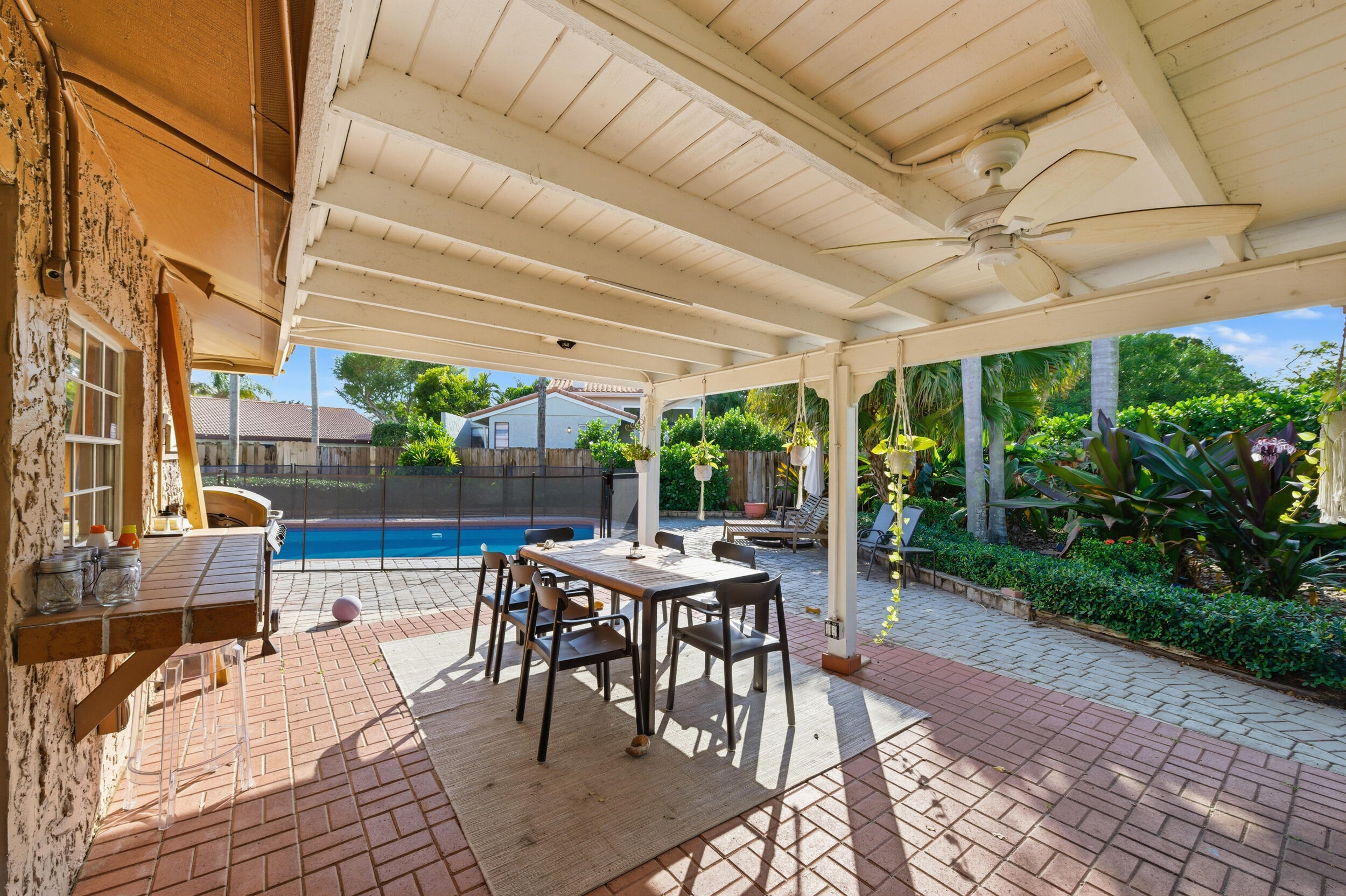 21089 Brookshire Terrace Boca Raton, FL 33433 - Photo 14 of 30 a view of a patio with a table and chairs under an umbrella