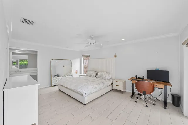 a bedroom with a bed and chair