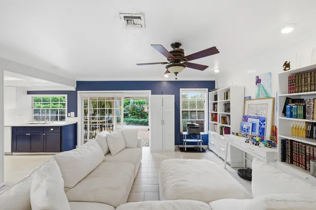 a living room with furniture and large window