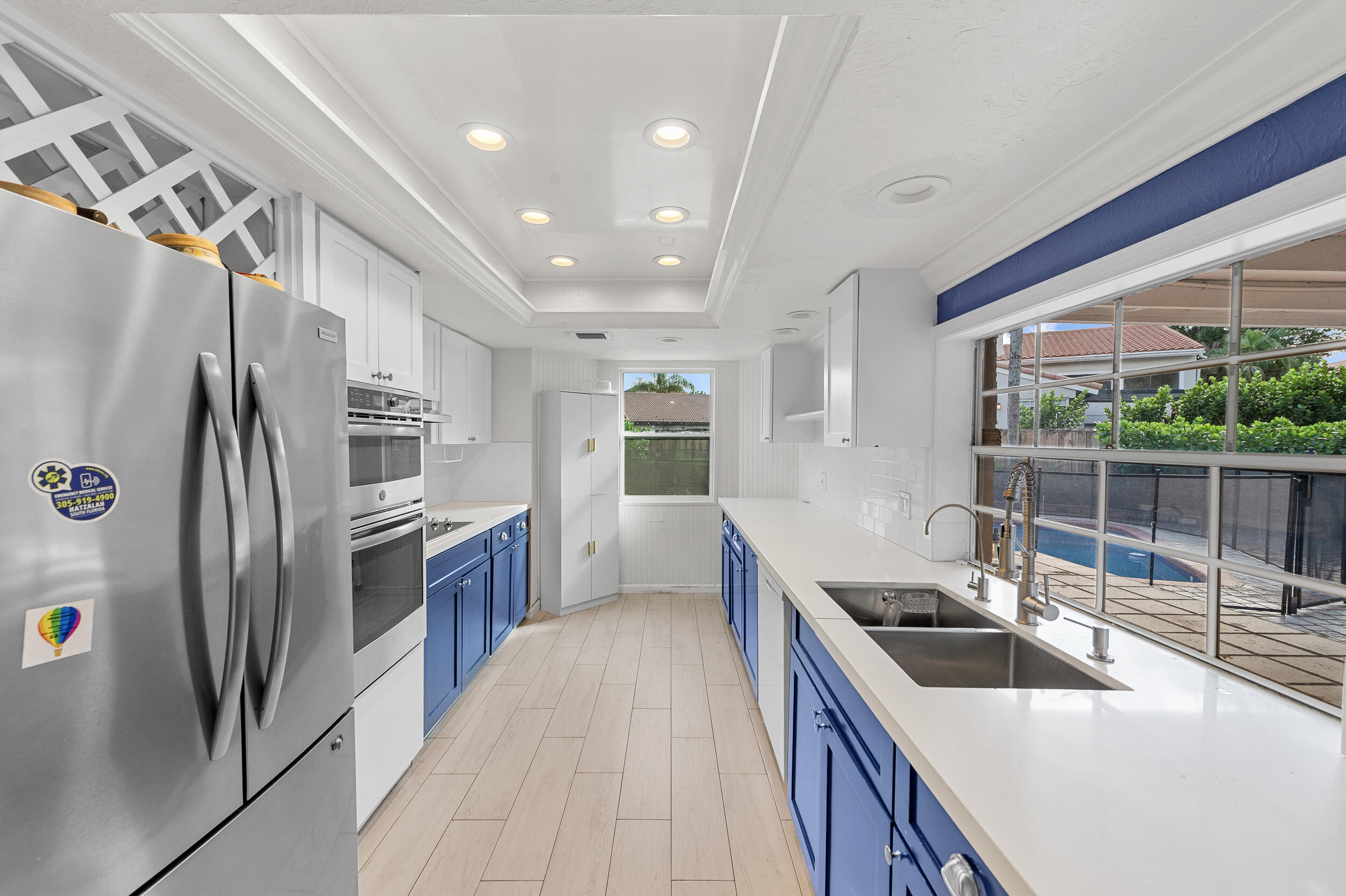 21089 Brookshire Terrace Boca Raton, FL 33433 - Photo 10 of 30 a kitchen with stainless steel appliances a sink stove and refrigerator