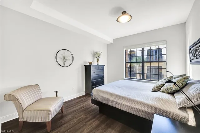 a bedroom with a bed window and a chandelier