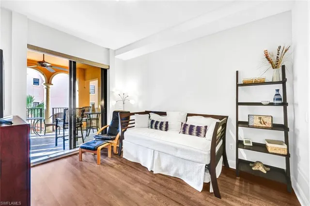 a living room with furniture and a floor to ceiling window