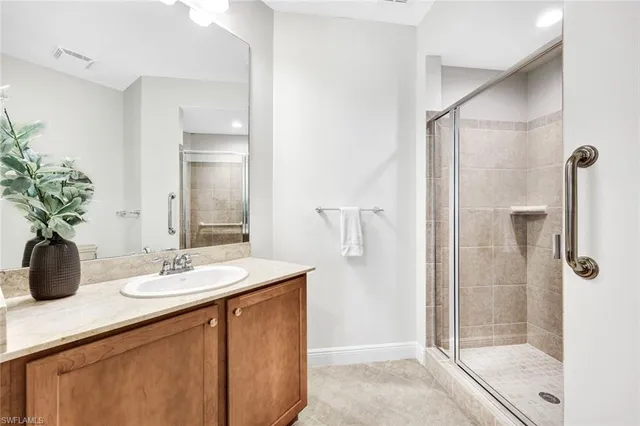 a bathroom with a shower sink and mirror