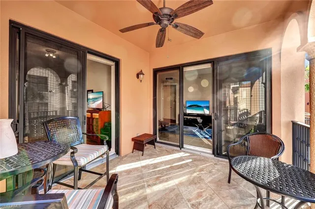a living room with furniture a rug and white walls
