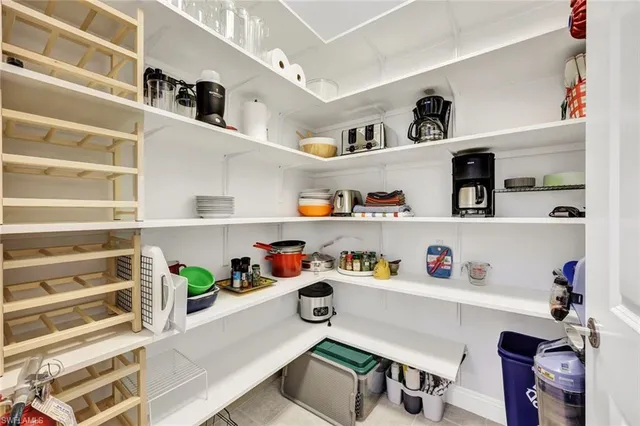 a utility room with lots of clutter and cabinets