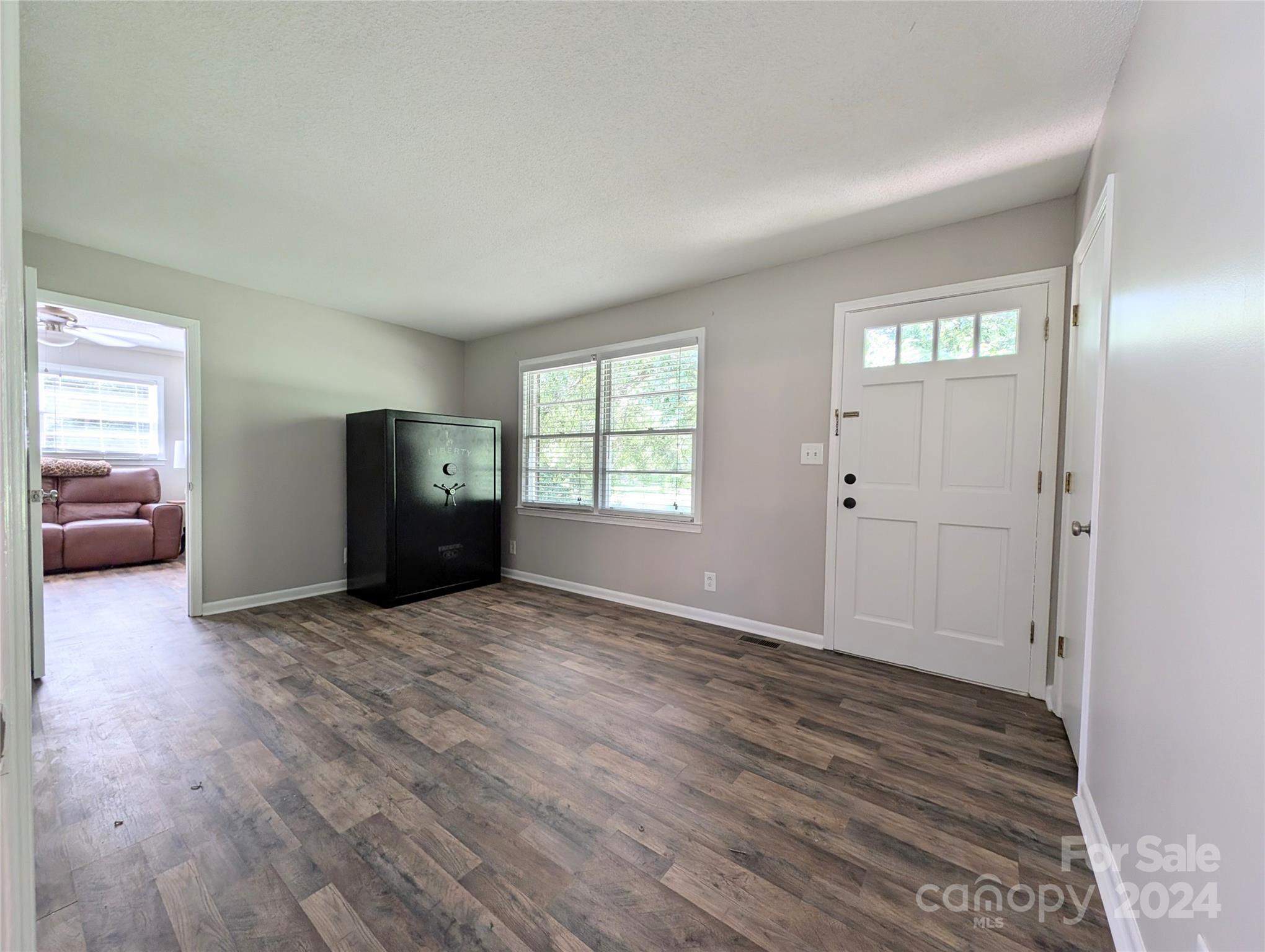 1285 Rainbow Circle Catawba, SC 29704 - Photo 5 of 23 a view of an empty room with window and wooden floor