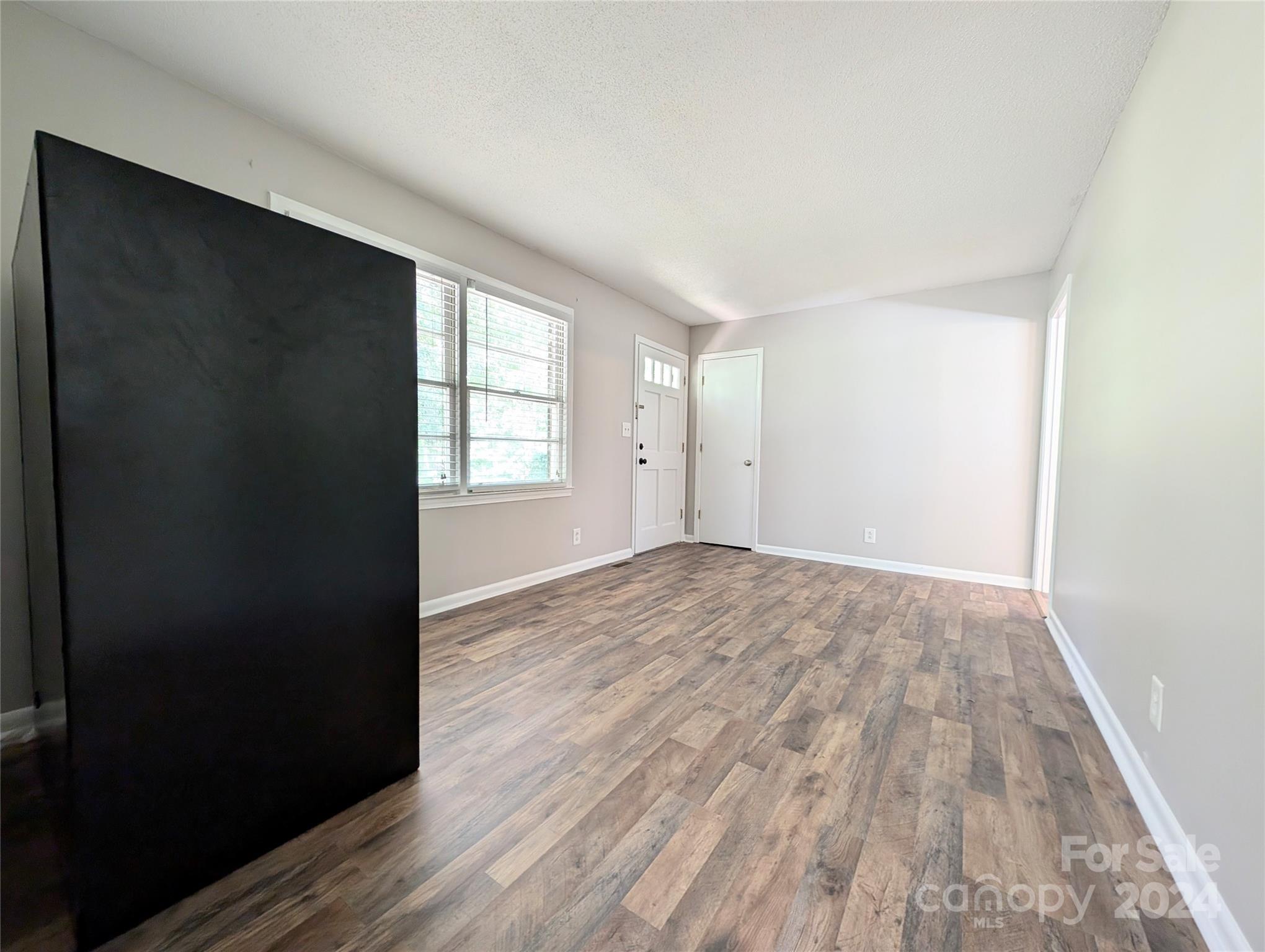 1285 Rainbow Circle Catawba, SC 29704 - Photo 6 of 23 a view of empty room with wooden floor and fan