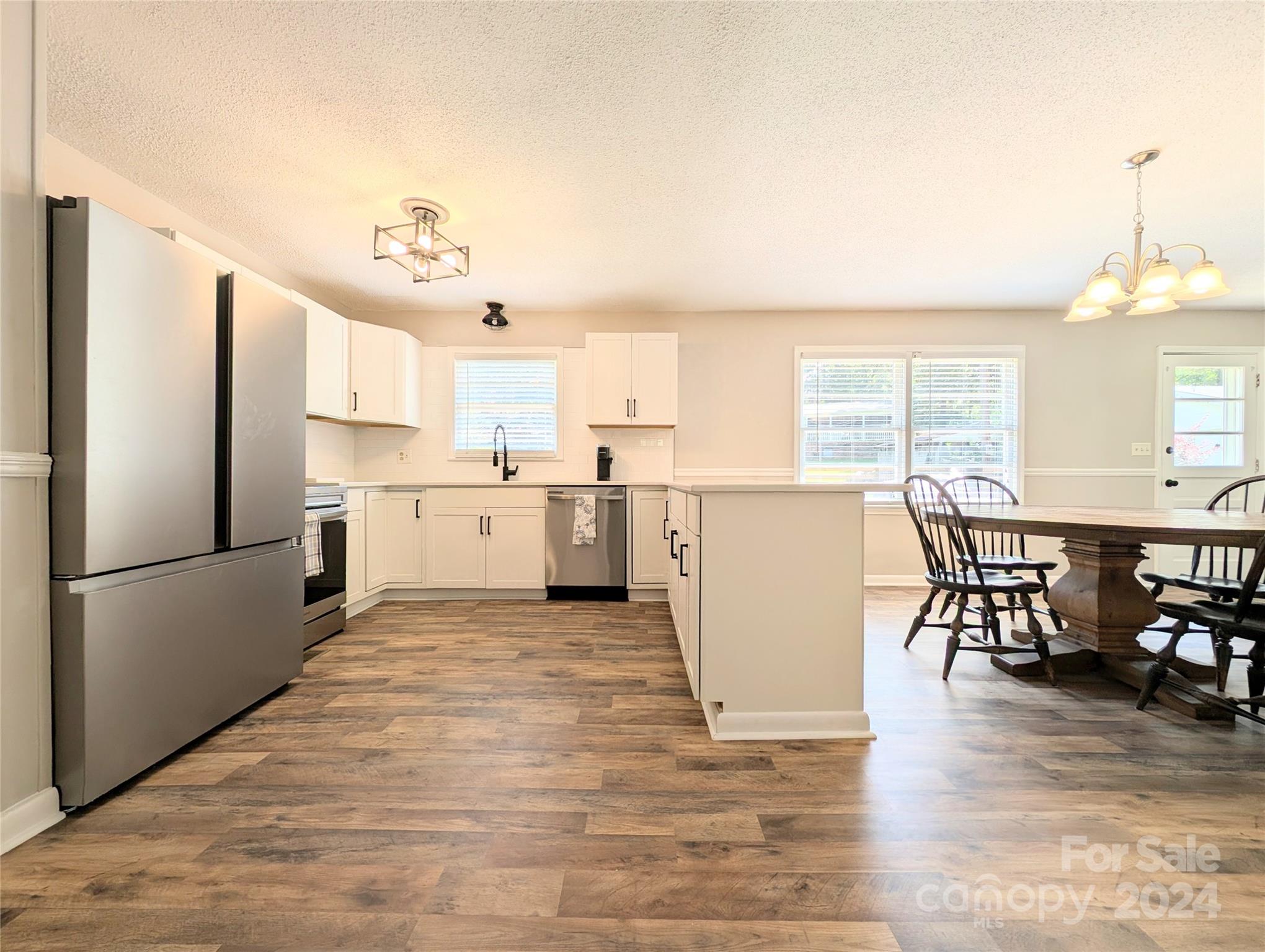 1285 Rainbow Circle Catawba, SC 29704 - Photo 7 of 23 a kitchen with a refrigerator a dining table and chairs