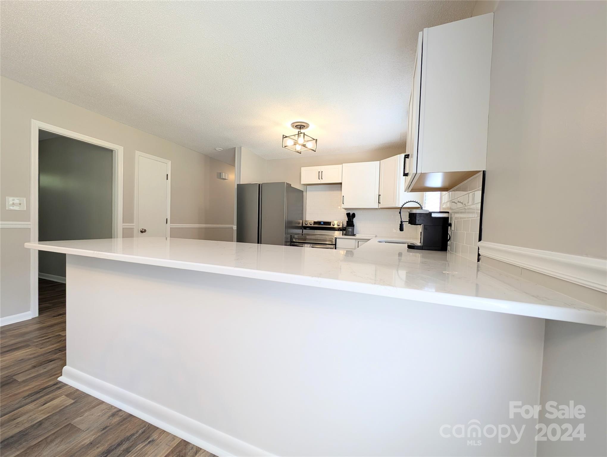 1285 Rainbow Circle Catawba, SC 29704 - Photo 9 of 23 a large white kitchen with kitchen island granite countertop a sink and a refrigerator
