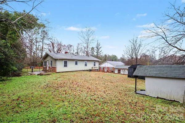 a view of a house with a wooden fence