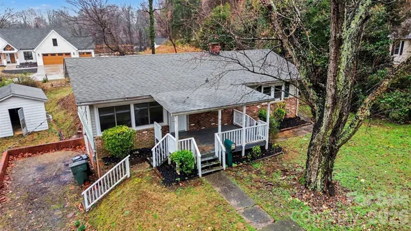 a view of house with yard and sitting area