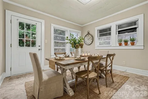 a view of a dining room with furniture and window