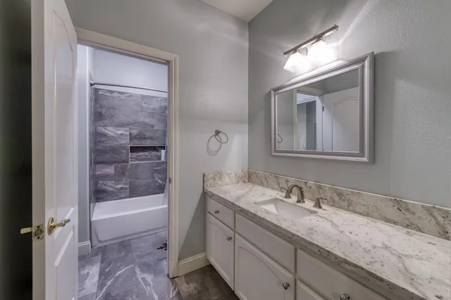 a bathroom with a bathtub and a sink