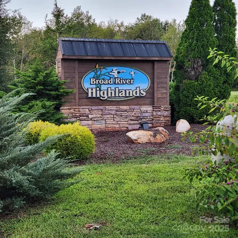 a view of a back yard with swimming pool and green space