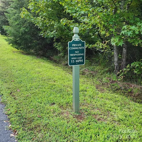 a sign that is sitting in the middle of a forest