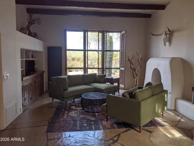 a spacious bedroom with a bed and a fireplace