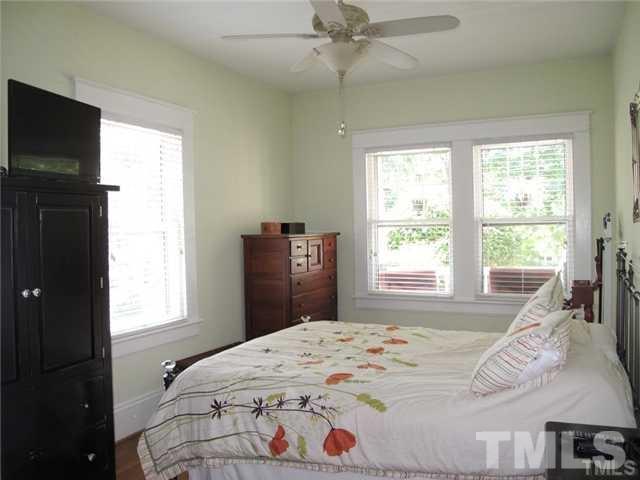2221 The Circle Raleigh, NC 27608 - Photo 9 of 15 a bedroom with a bed and a large window