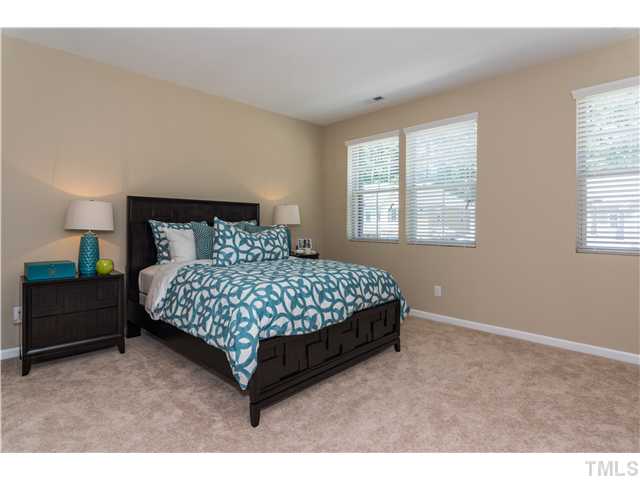 707 Wickham Ridge Road, Unit 160 Apex, NC 27539 - Photo 12 of 21 a bedroom with a bed lamp and window