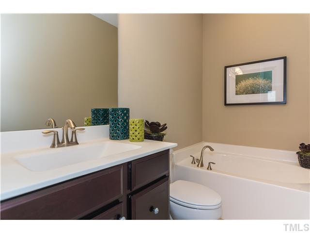707 Wickham Ridge Road, Unit 160 Apex, NC 27539 - Photo 14 of 21 a bathroom with a sink and a bathtub