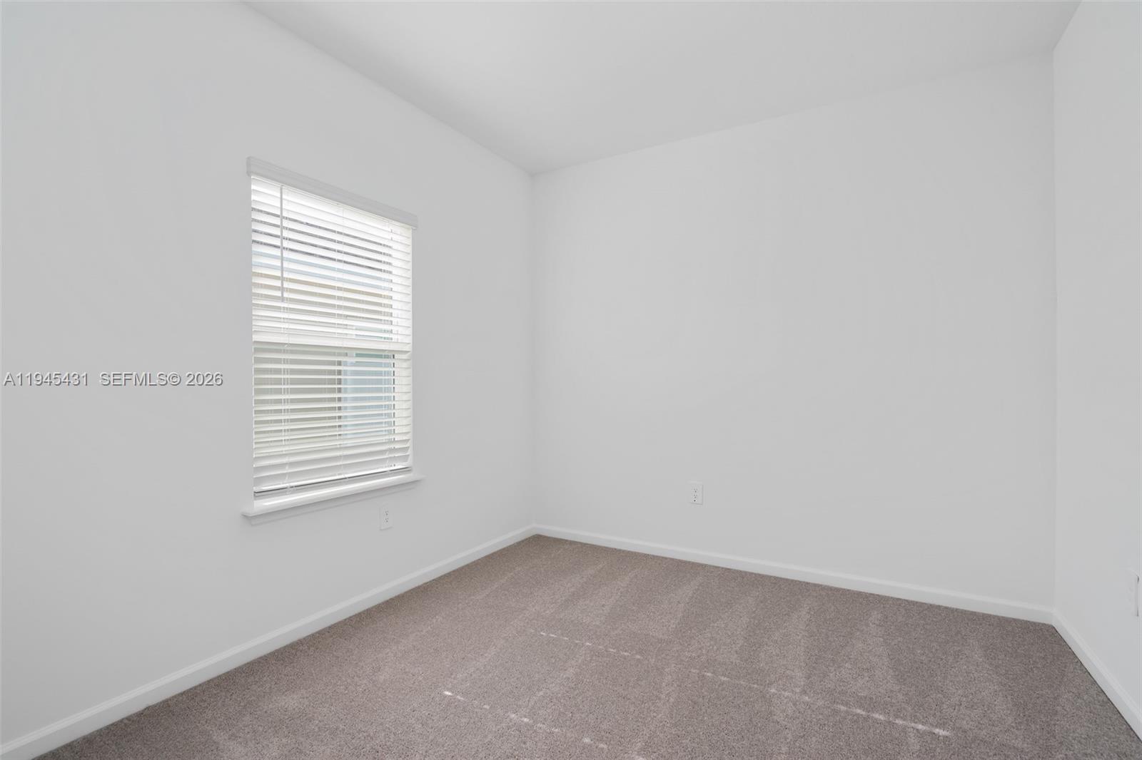 8934 Southwest 69th Terrace Ocala, FL 34476 - Photo 13 of 41 an empty room with a window
