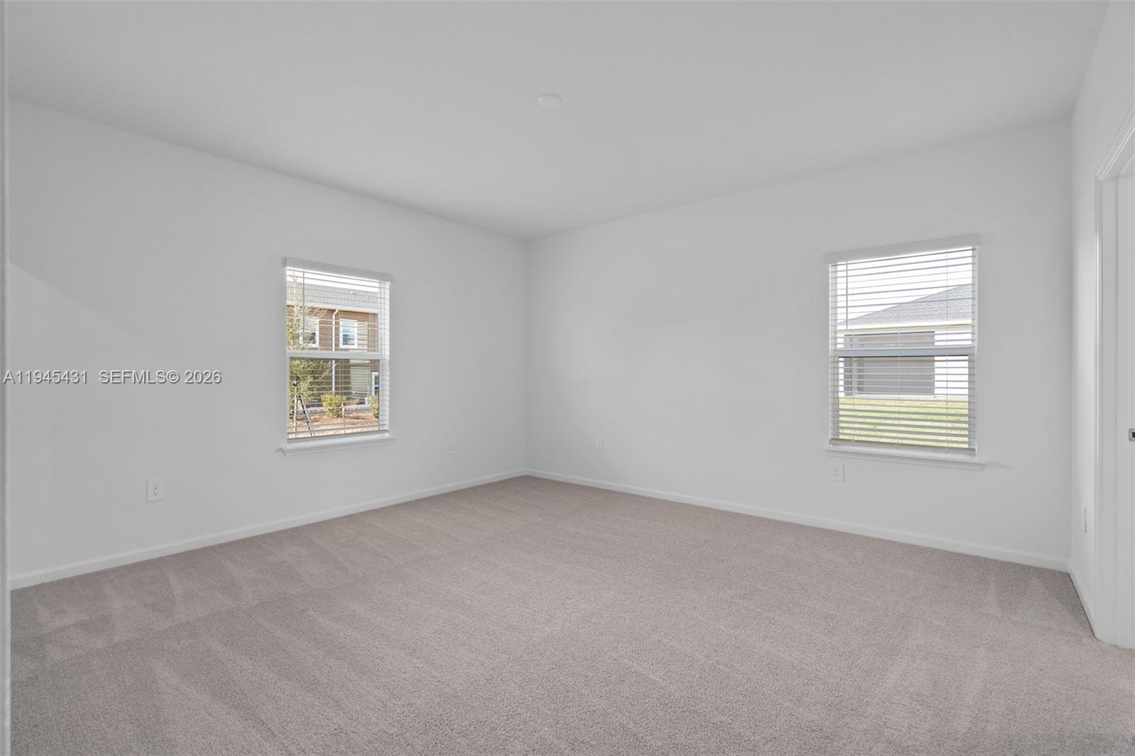 8934 Southwest 69th Terrace Ocala, FL 34476 - Photo 19 of 41 an empty room with windows