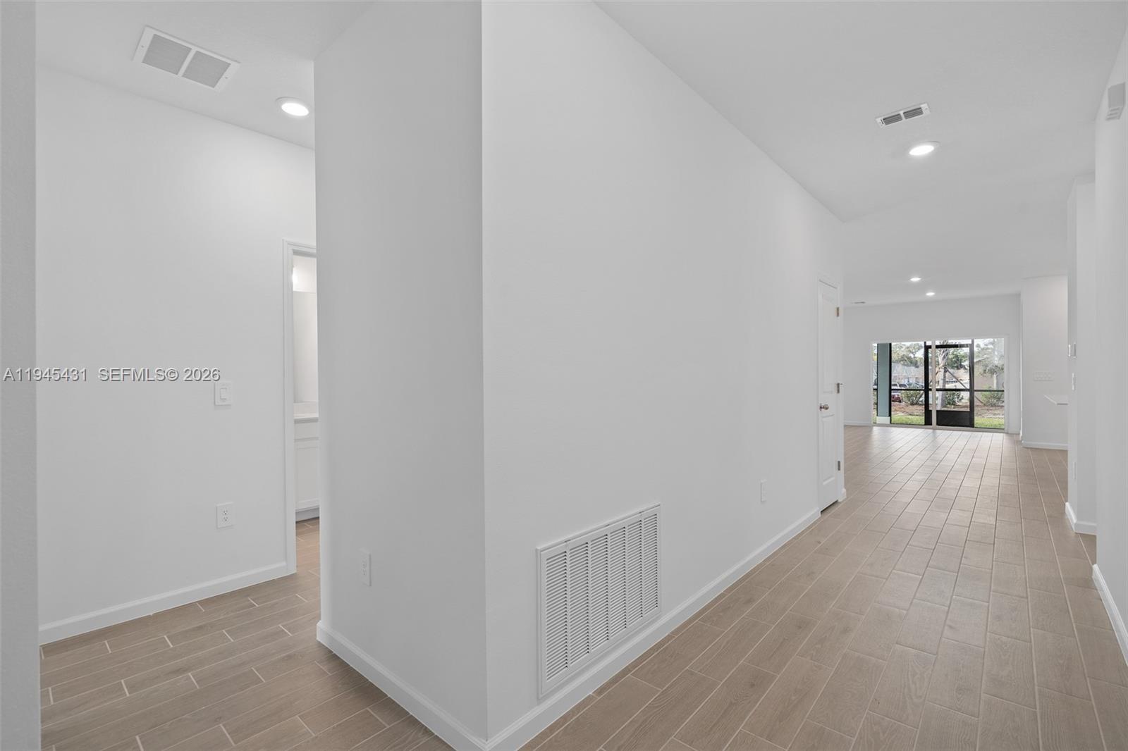 8934 Southwest 69th Terrace Ocala, FL 34476 - Photo 2 of 41 a view of a hallway with wooden floor