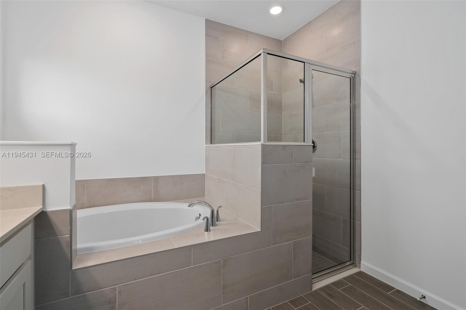 8934 Southwest 69th Terrace Ocala, FL 34476 - Photo 24 of 41 a bathroom with a bathtub and a shower