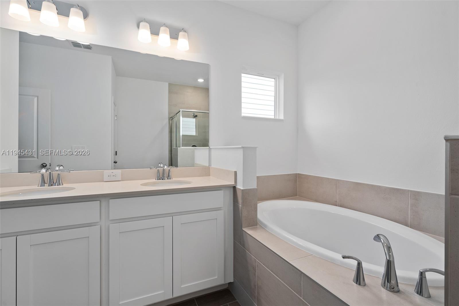 8934 Southwest 69th Terrace Ocala, FL 34476 - Photo 25 of 41 a bathroom with a tub sink and mirror
