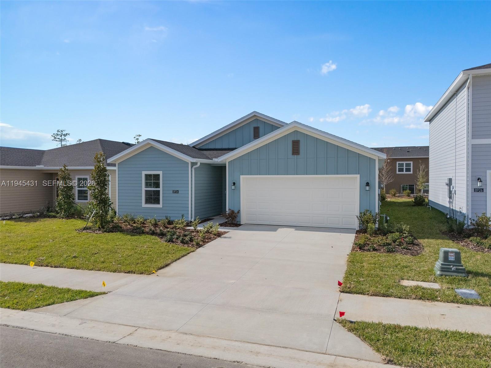 8934 Southwest 69th Terrace Ocala, FL 34476 - Photo 30 of 41 a front view of a house with a yard and garage