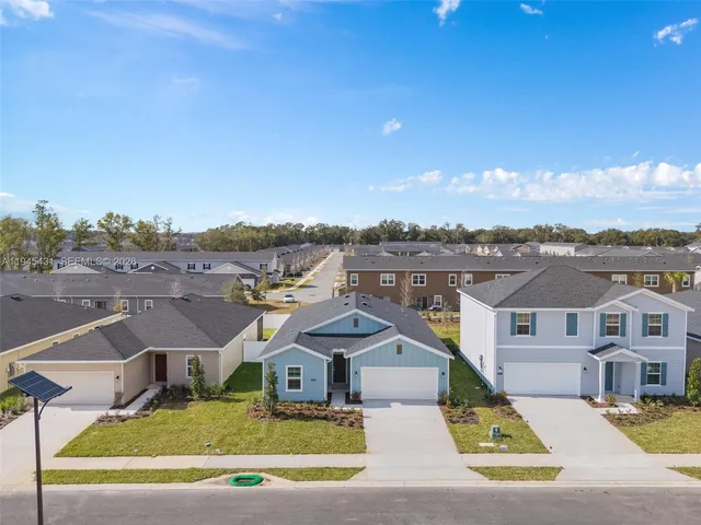 a view of a white house with a ocean view