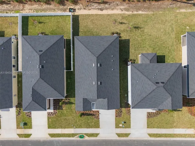 aerial view of a house with a yard