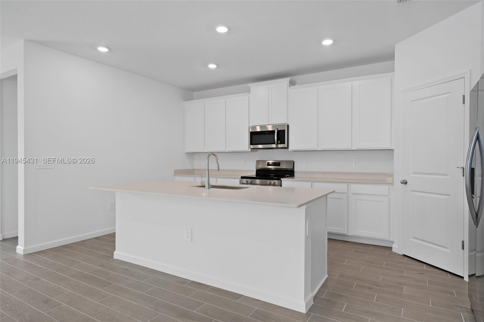 8934 Southwest 69th Terrace Ocala, FL 34476 - Photo 6 of 41 a kitchen with cabinets appliances a sink and a counter top space