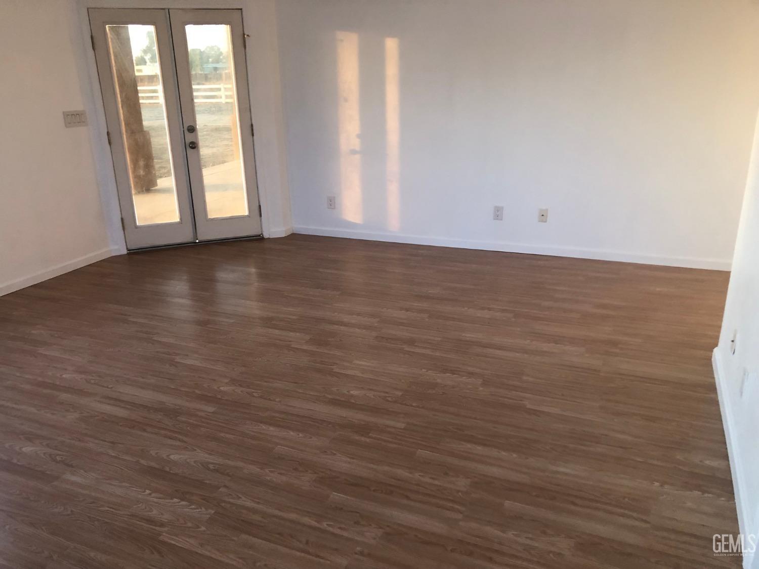 Undisclosed Address Bakersfield, CA 93314 - Photo 11 of 21 a view of an empty room with wooden floor and a window