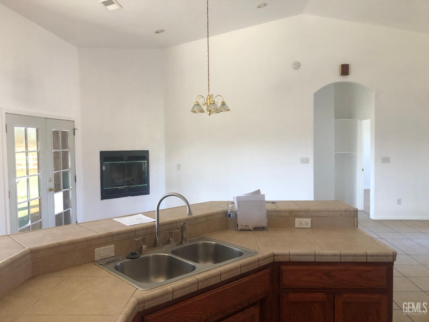 Undisclosed Address Bakersfield, CA 93314 - Photo 14 of 21 a kitchen with a sink and a stove with wooden floor