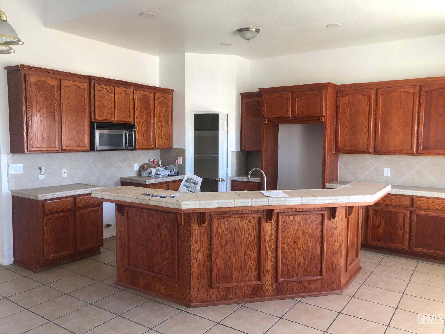 Undisclosed Address Bakersfield, CA 93314 - Photo 17 of 21 a kitchen with stainless steel appliances granite countertop wooden cabinets a sink and dishwasher