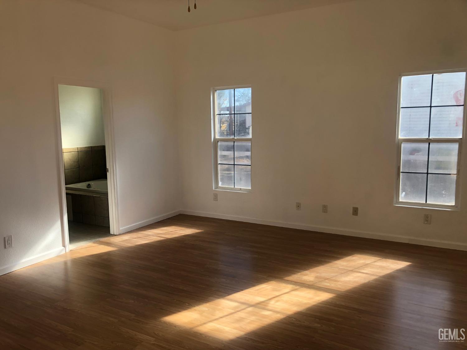 Undisclosed Address Bakersfield, CA 93314 - Photo 19 of 21 an empty room with wooden floor closet and windows