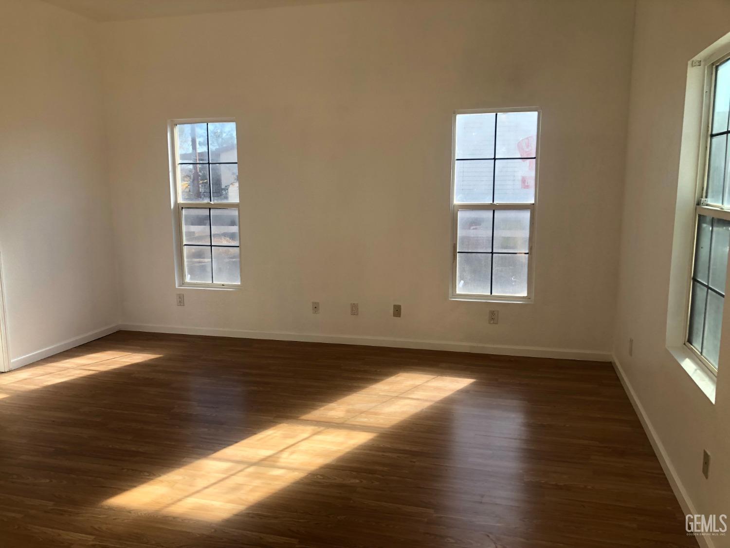 Undisclosed Address Bakersfield, CA 93314 - Photo 20 of 21 an empty room with wooden floor and windows