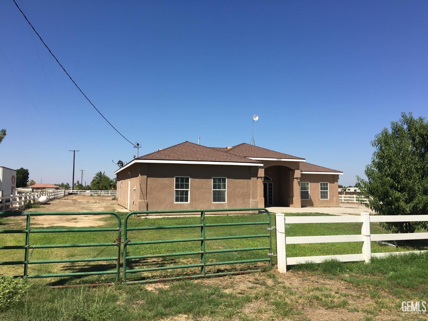 Undisclosed Address Bakersfield, CA 93314 - Photo 2 of 21 a front view of a house with a yard
