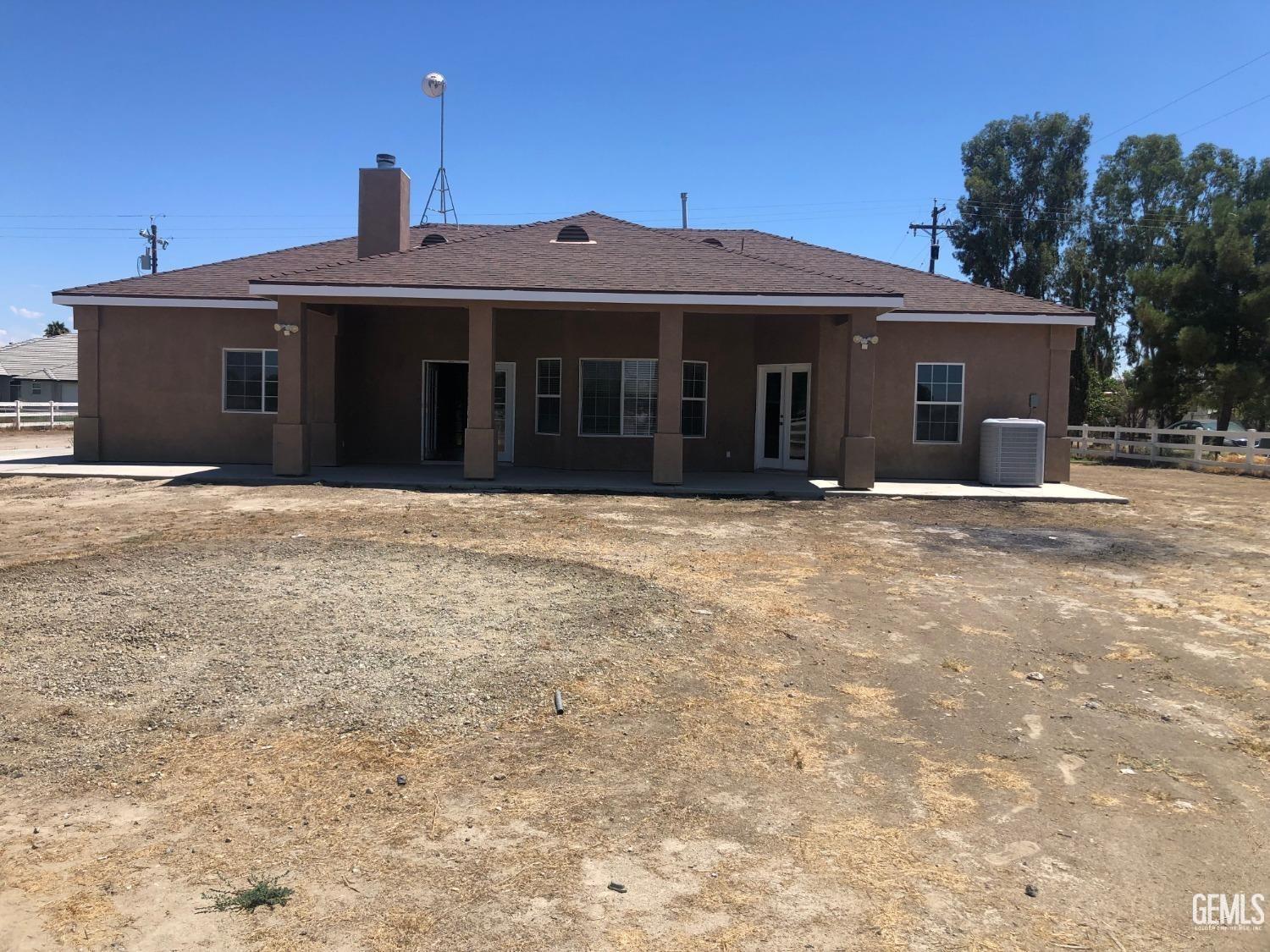 Undisclosed Address Bakersfield, CA 93314 - Photo 4 of 21 a front view of a house with a yard