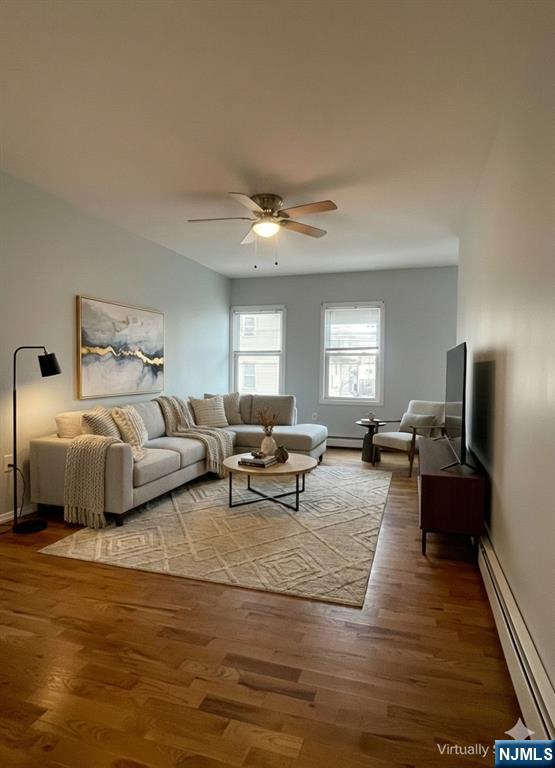 82-84 Maple Avenue, Unit 2 Wallington, NJ 07057 - Photo 4 of 12 a living room with furniture and a chandelier
