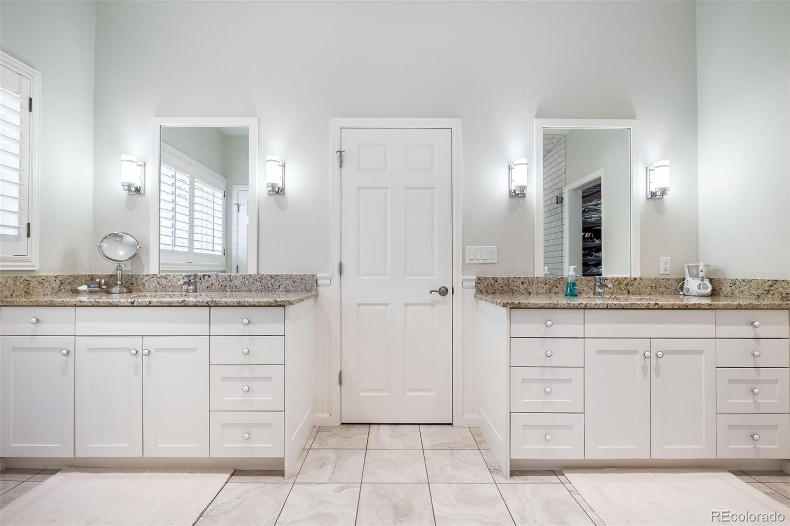 16609 West 77th Drive Arvada, CO 80007 - Photo 15 of 48 a bathroom with a granite countertop double vanity sink and a mirror