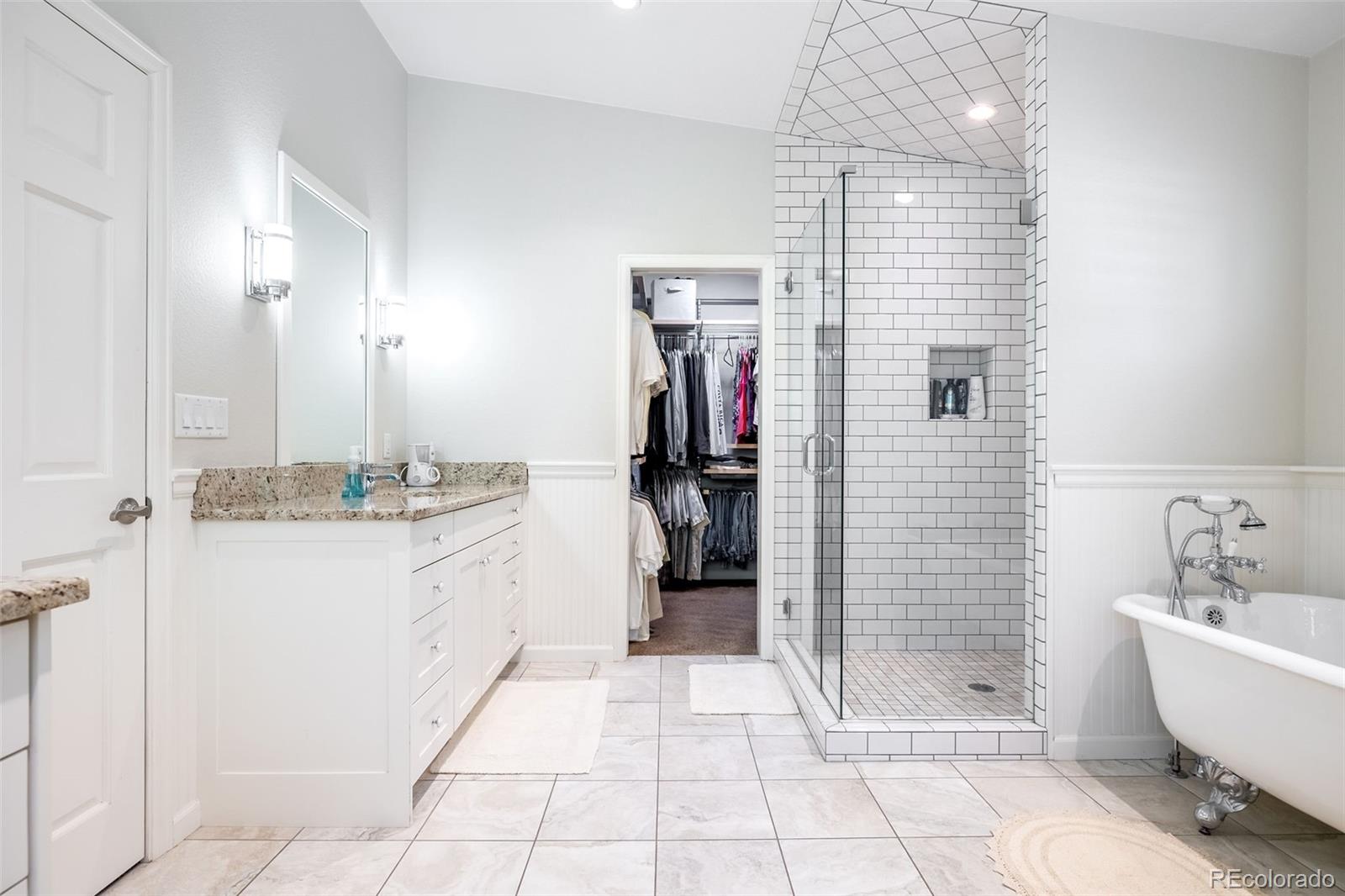 16609 West 77th Drive Arvada, CO 80007 - Photo 16 of 48 a bathroom with a granite countertop sink a toilet and shower