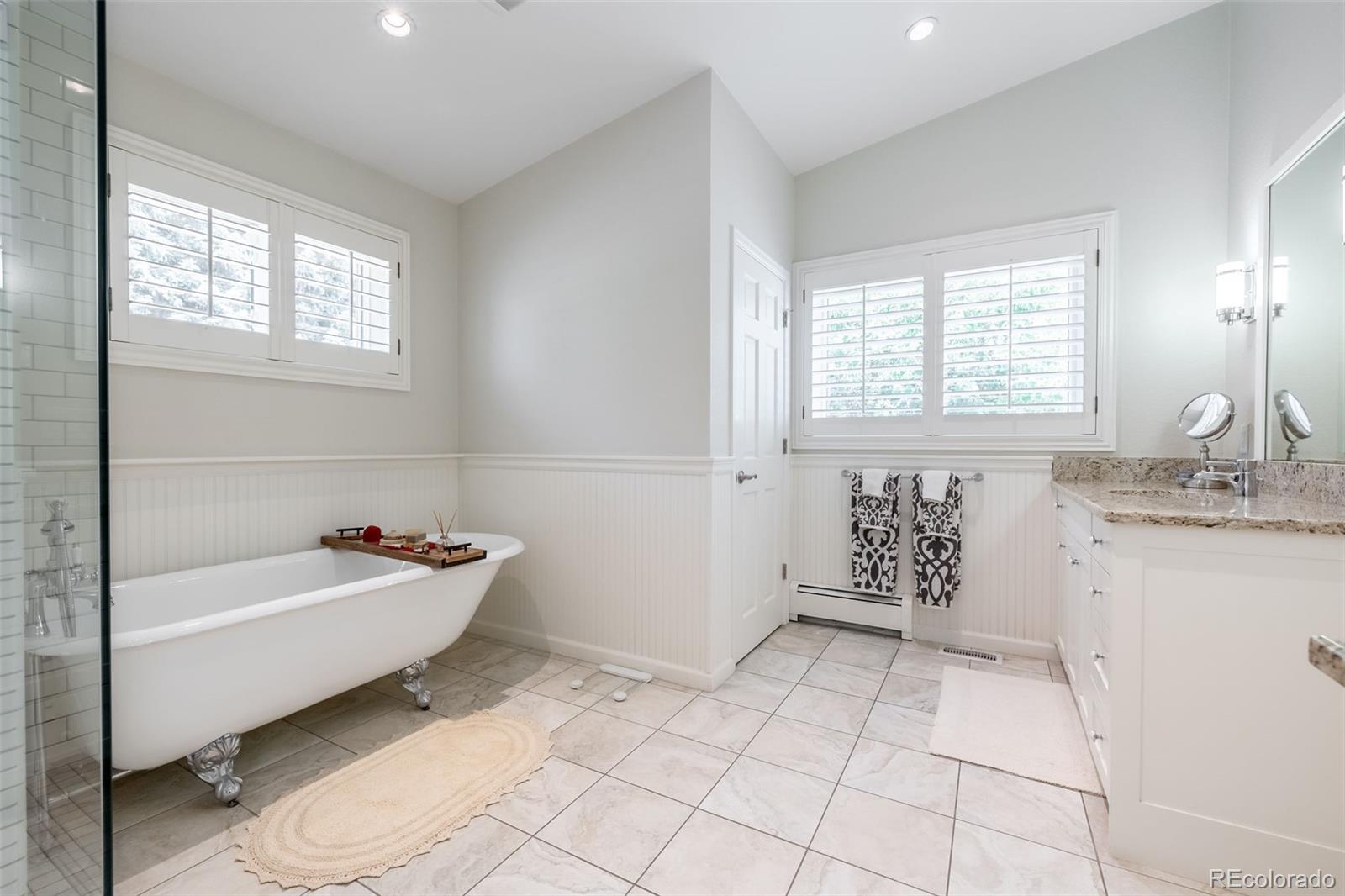 16609 West 77th Drive Arvada, CO 80007 - Photo 17 of 48 a bathroom with a bathtub sink and mirror