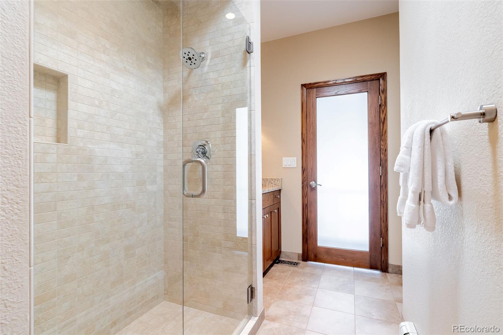 16609 West 77th Drive Arvada, CO 80007 - Photo 22 of 48 a bathroom with a shower and a sink