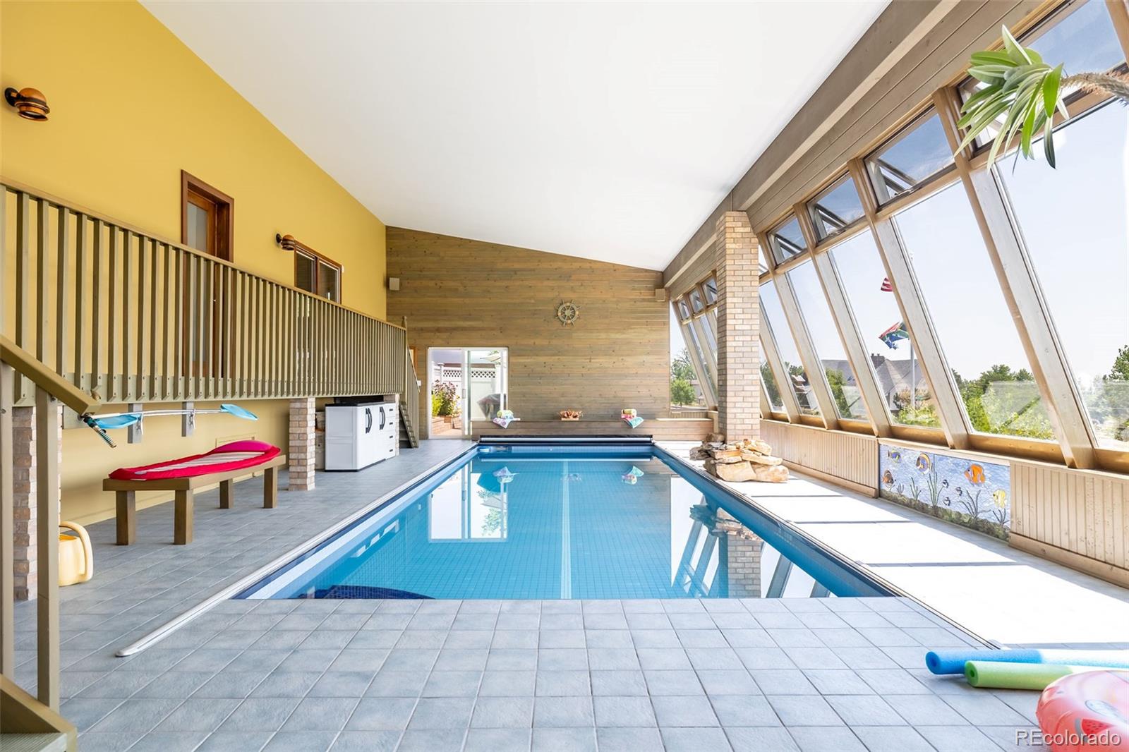 16609 West 77th Drive Arvada, CO 80007 - Photo 34 of 48 a swimming pool with chairs