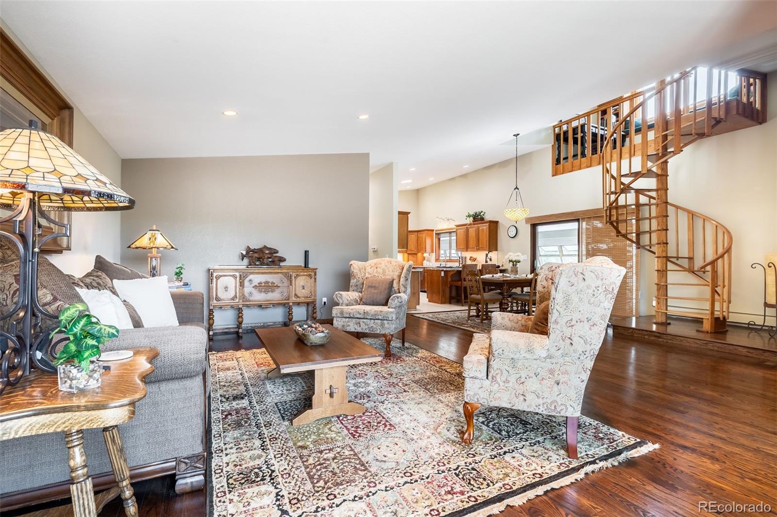 16609 West 77th Drive Arvada, CO 80007 - Photo 4 of 48 a living room with fireplace furniture and a wooden floor