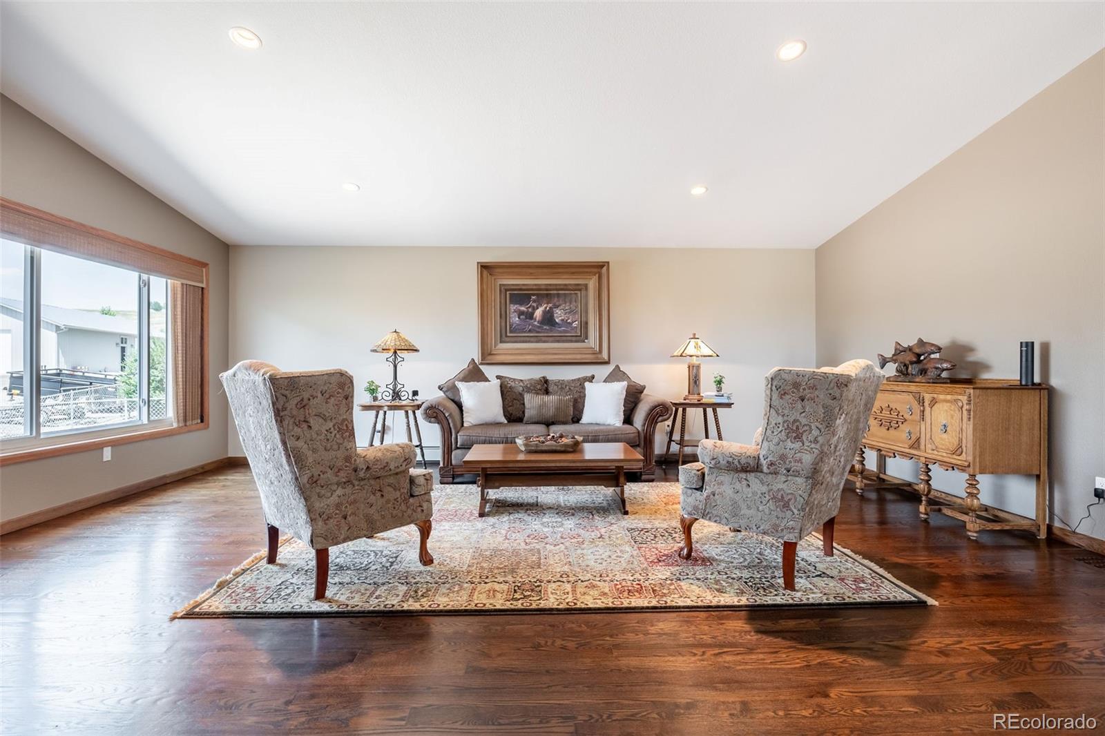 16609 West 77th Drive Arvada, CO 80007 - Photo 5 of 48 a living room with furniture and a large window