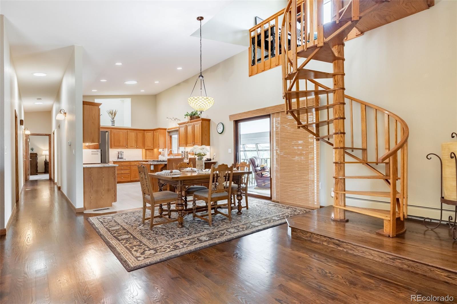 16609 West 77th Drive Arvada, CO 80007 - Photo 6 of 48 a view of a dining room with furniture window and wooden floor